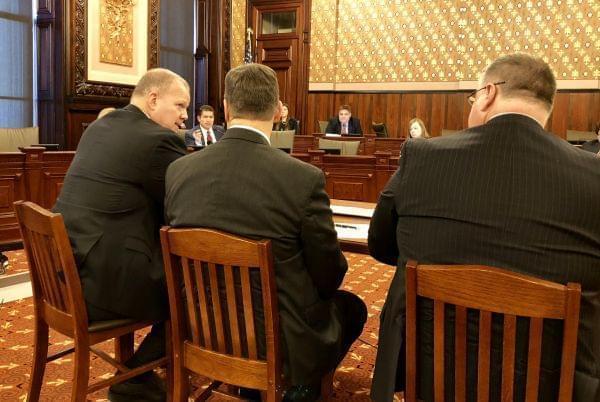 State Sen. Kyle McCarter (in the red necktie) questions Illinois State Board of Education Superintendent Tony Smith (left) about his "unrealistic" budget request.