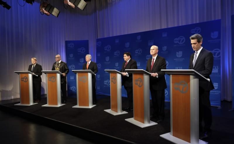 Democratic gubernatorial candidates Robert Marshall, Tio Hardiman, Chris Kennedy, J.B. Pritzker, Bob Daiber, and Illinois Sen. Daniel Biss, left to right, participate in a debate Friday, March 2, 2018, in Chicago.  