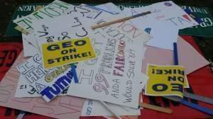 Posters and signs with strike slogans written on them. Signs are part of the GEO strike on the University of Illinois Urbana-Champaign campus. 