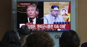 People watch a TV screen showing North Korean leader Kim Jong Un and U.S. President Donald Trump at the Seoul Railway Station in Seoul, South Korea, Friday, March 9.The headlines on the TV screen reads: " Kim Jong Un understands that the routine