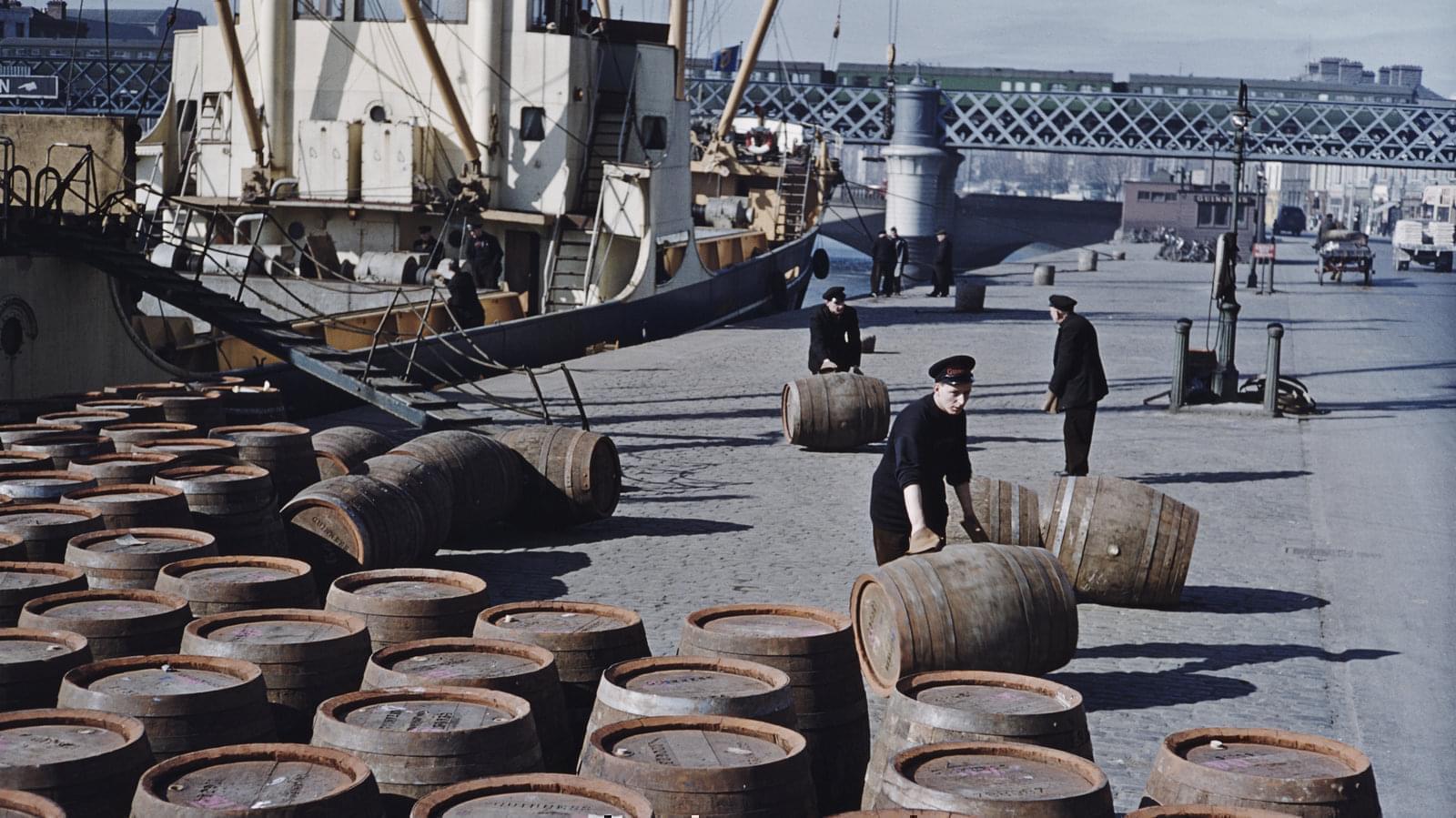 Workers roll potentially lifesaving barrels of Guinness in June 1955 on a quayside in Dublin.
