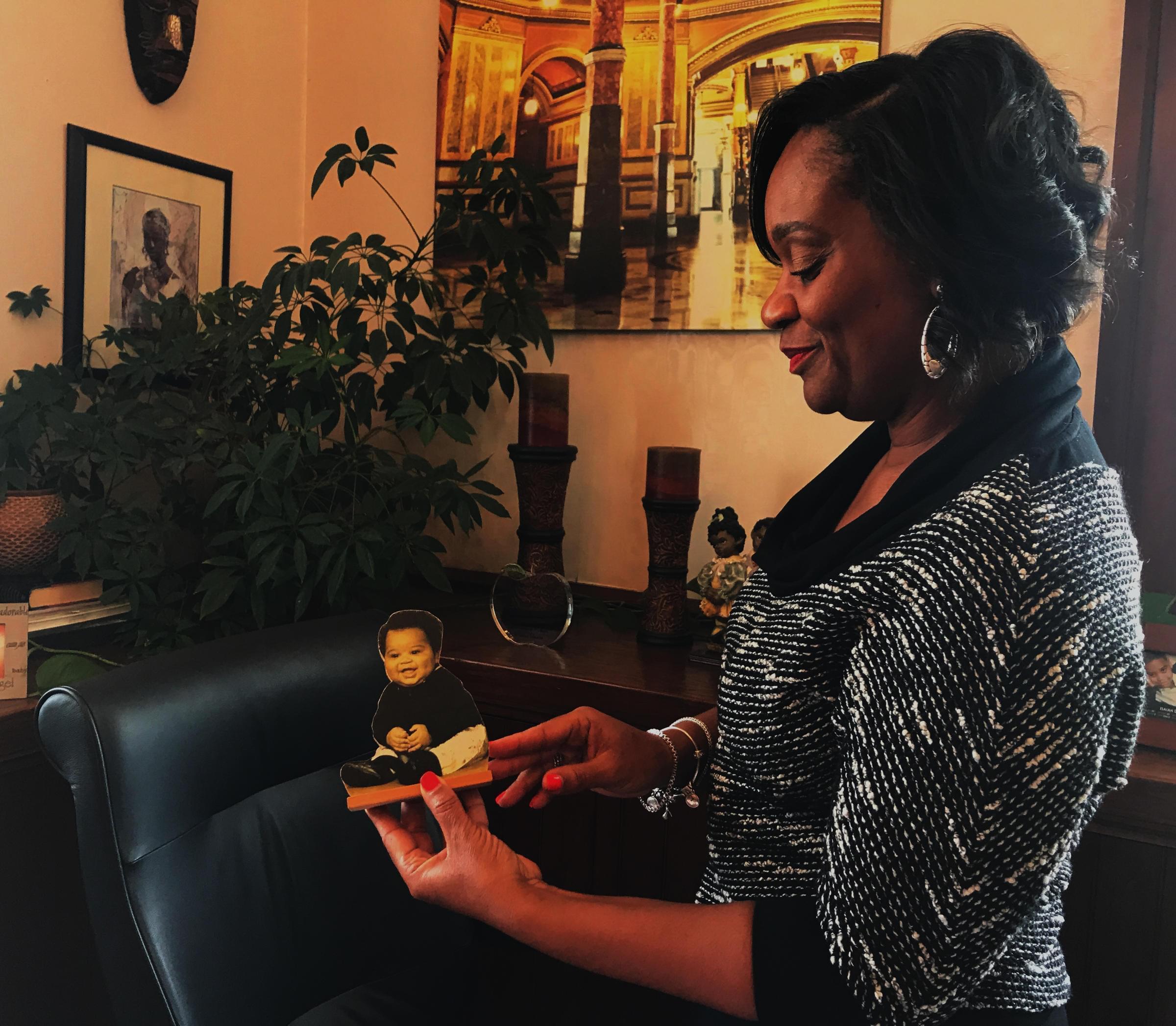 State Sen. Kimberly Lightford shows a picture of her son, Isaiah, who she had while serving in the Illinois Senate.