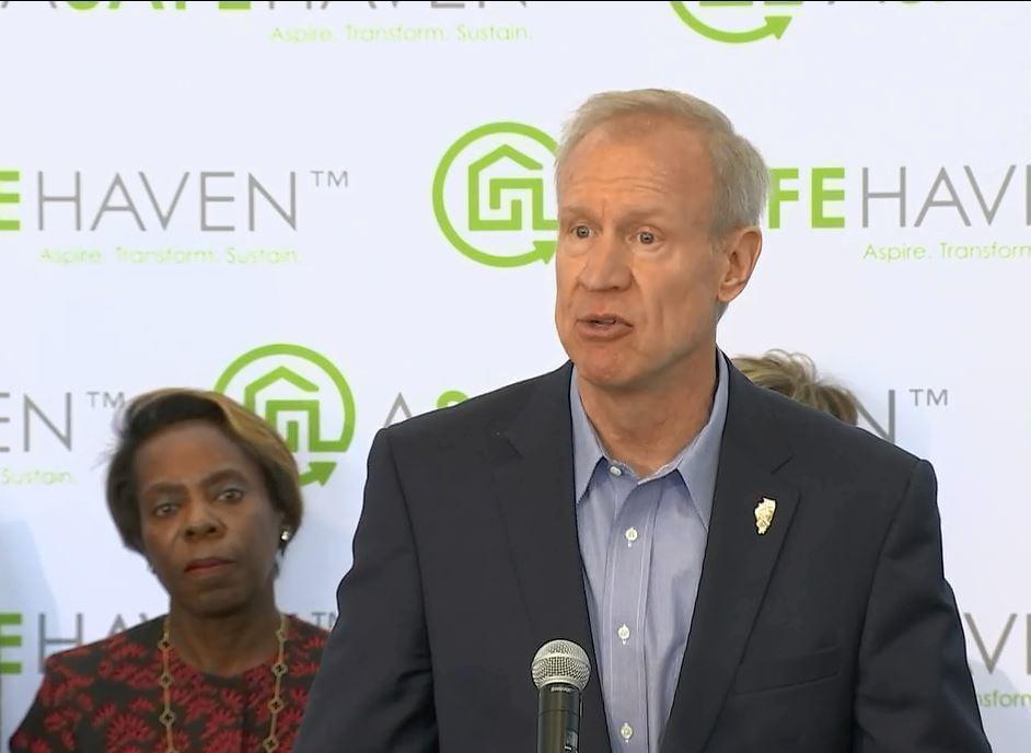 Gov. Bruce Rauner announces the new program at an event in Chicago on May 7, while HFS Director Felicia Norwood, left, looks on.