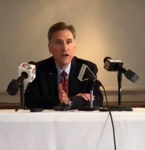 SIU President Randy Dunn speaking into a microphone at a news conference