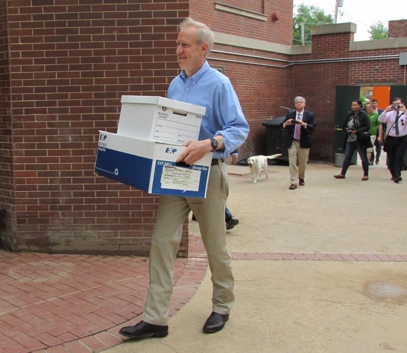 Gov. Bruce Rauner moves a few boxes into his newly-occupied residence at the Governor's Mansion in Springfield