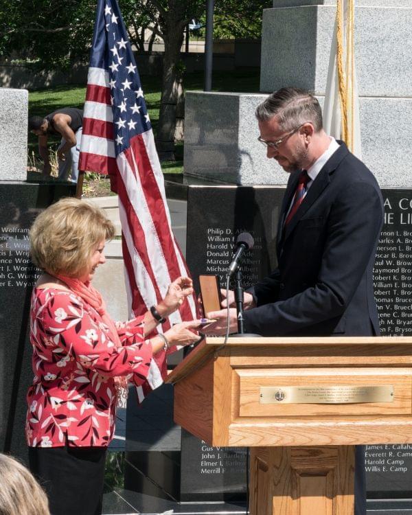 Connie Barr receives her father's Purple Heart from Illinois State Treasurer Michael Frerichs