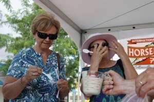 Taste-testers feel the burn after trying some freshly blended horseradish at the Collinsville, Illinois, festival.