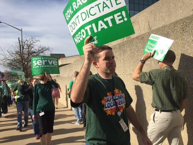 AFSCME members picket outside a state building in this 2016 file photo.
