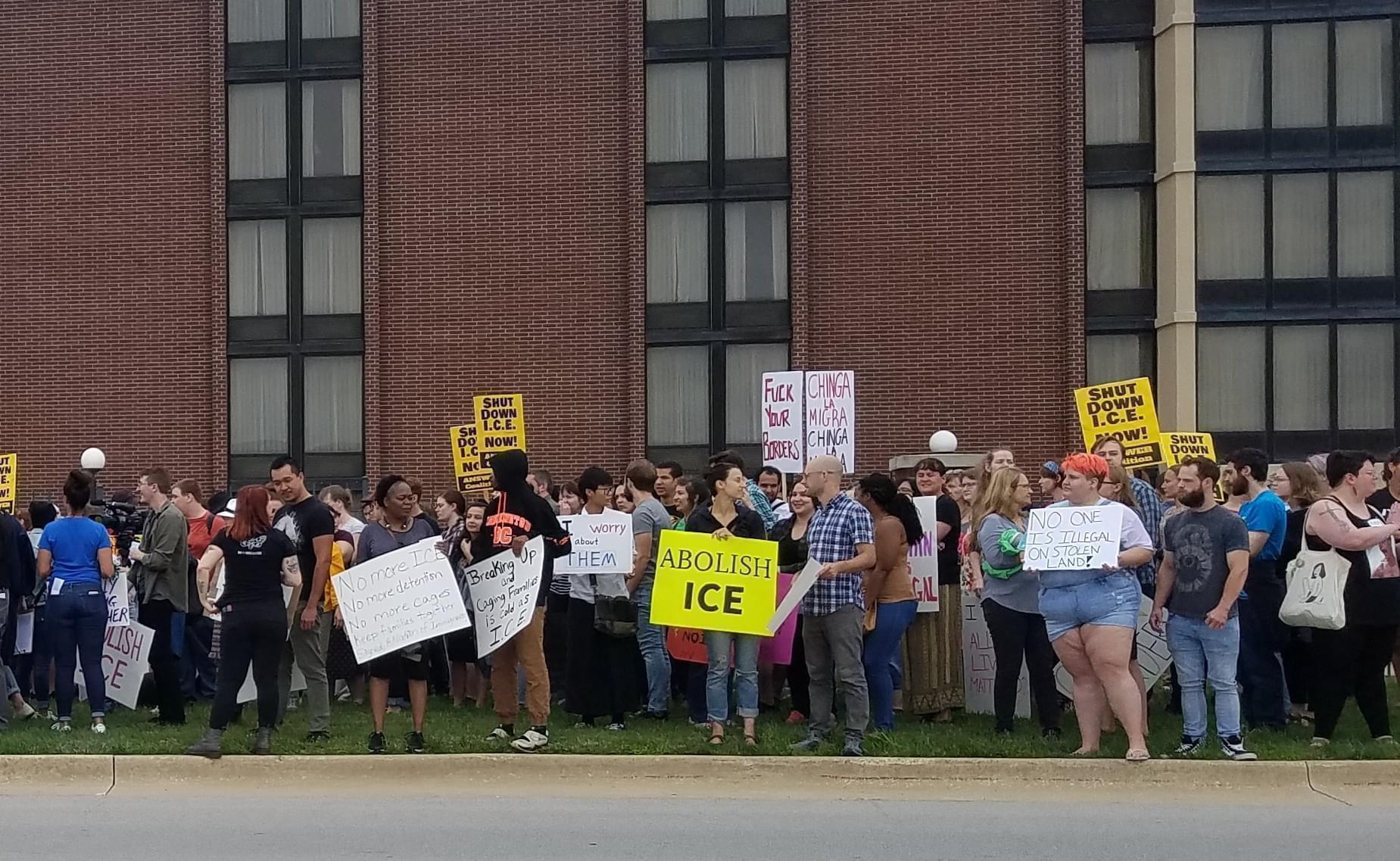 Demonstrators protesting ICE agents outside the Drury Inn & Suites in Champaign.