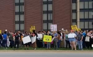 Demonstrators protesting ICE agents outside the Drury Inn & Suites in Champaign. 