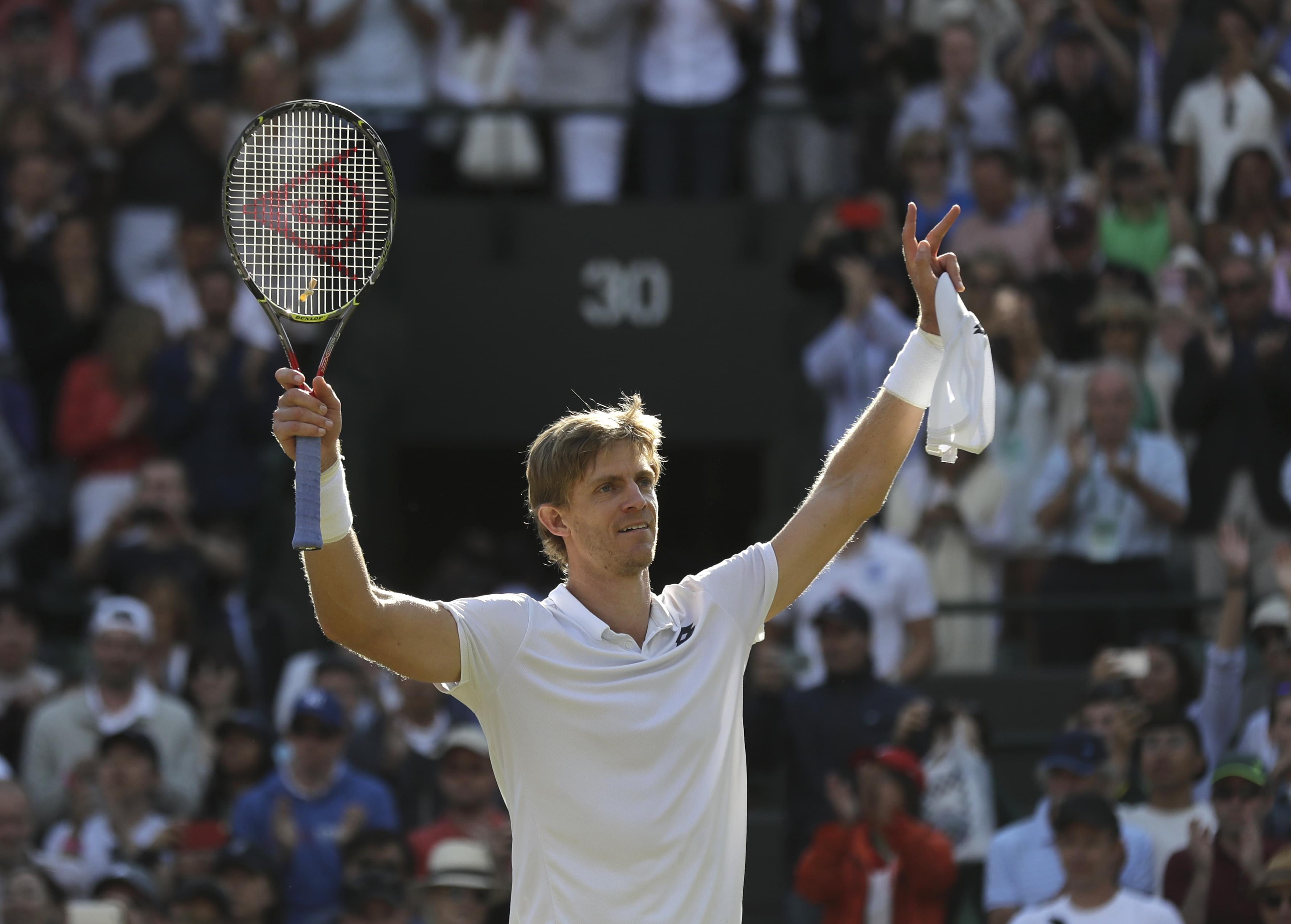 Kevin Anderson of South Africa celebrates winning his men's quarterfinals match against Switzerland's Roger Federer, at the Wimbledon Tennis Championships, in London, Wednesday July 11, 2018.