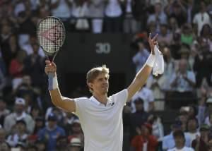 Kevin Anderson of South Africa celebrates winning his men's quarterfinals match against Switzerland's Roger Federer, at the Wimbledon Tennis Championships, in London, Wednesday July 11, 2018. 