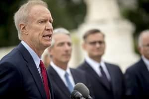 Illinois Gov. Bruce Rauner, left, accompanied by Liberty Justice Center founder and chairman John Tillman, second from left, and Liberty Justice Center's Director of Litigation Jacob Huebert, right, speaks outside the Supreme Court after the cou