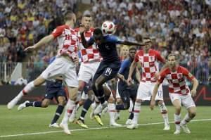 Croatia's Ivan Perisic, second left, handles the ball to give away a penalty as he jumps for the ball with France's Blaise Matuidi during the final match between France and Croatia. 