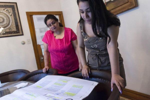 Delia Barajas and Elizabeth Morales, members of the community group Ixchel, review materials they’ve used to educate Cicero and Berwyn residents about school discipline and racial disparities.