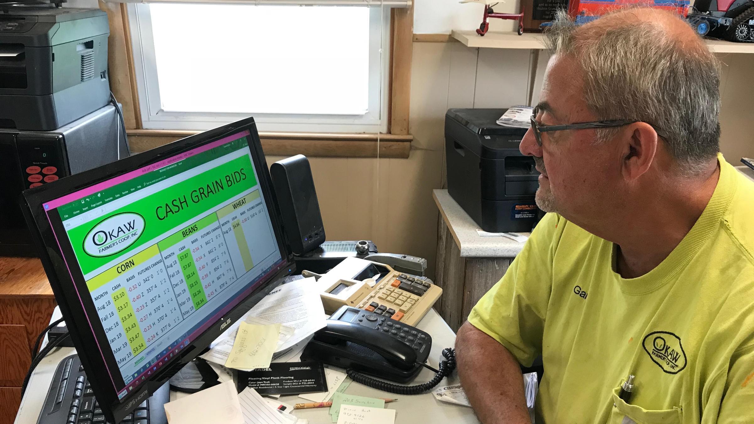 Gary Smith tracks the Chicago Board of Trade's corn, soy and wheat prices change at his office in the Okaw Farmer's Cooperative in Lovington.