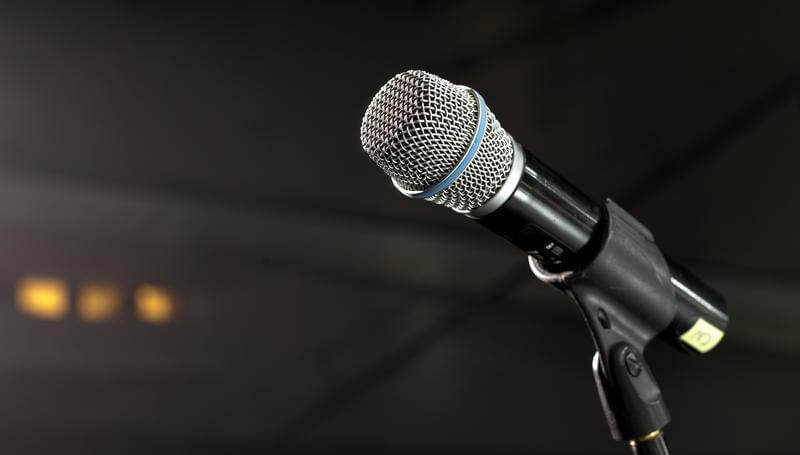 Stock photo of a microphone on a stand.