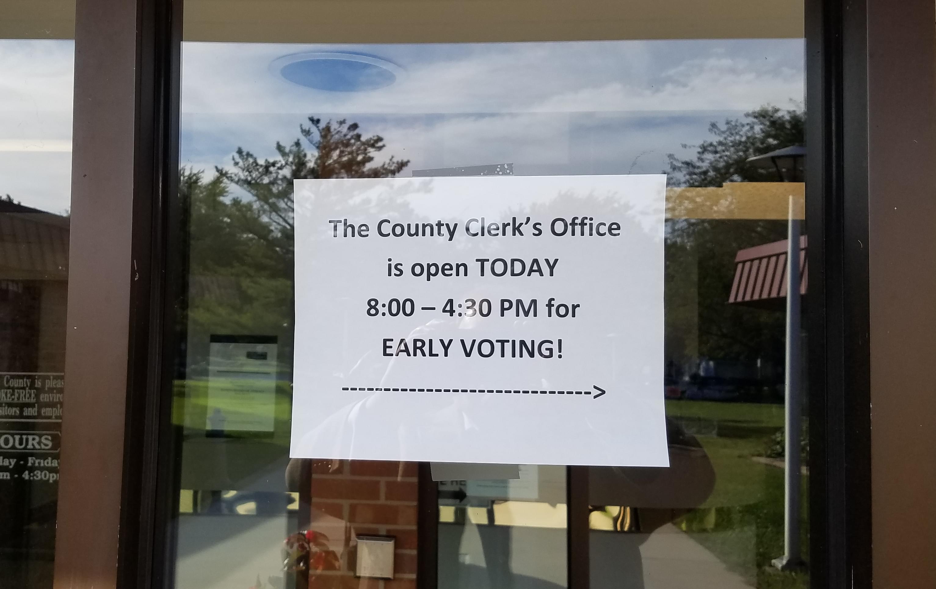 A sign directs people to the Champaign County Clerk's office for early voting.