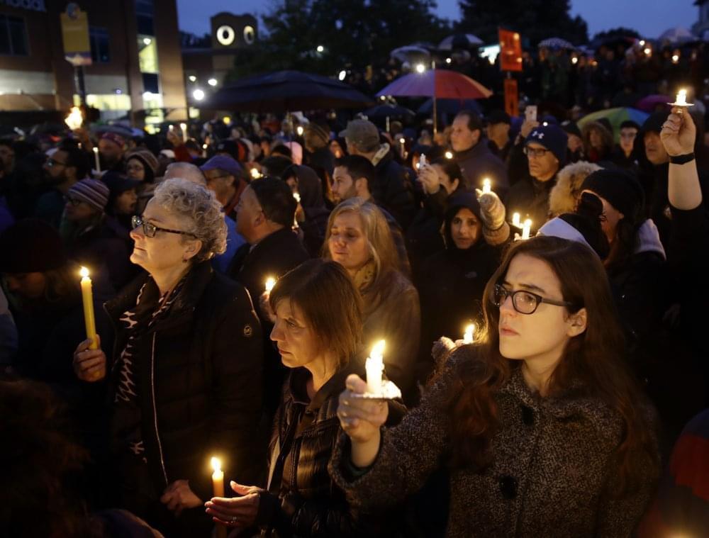 People hold candles as they gather for a vigil in the aftermath of a deadly shooting at the Tree of Life Congregation, in the Squirrel Hill neighborhood of Pittsburgh, Saturday, Oct. 27, 2018.