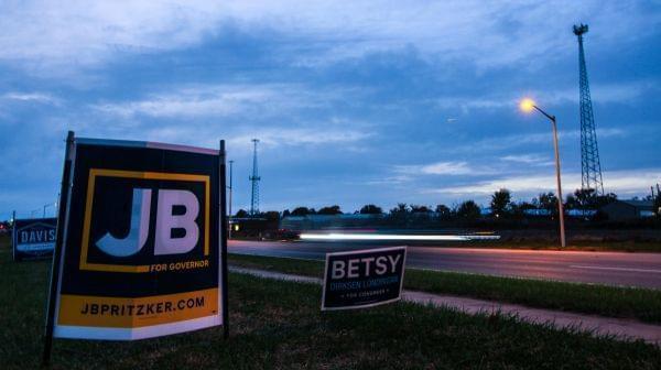 Cars pass a sign for gubernatorial candidate J.B. Pritzker about an hour before the polls closed on Nov. 6, 2018.