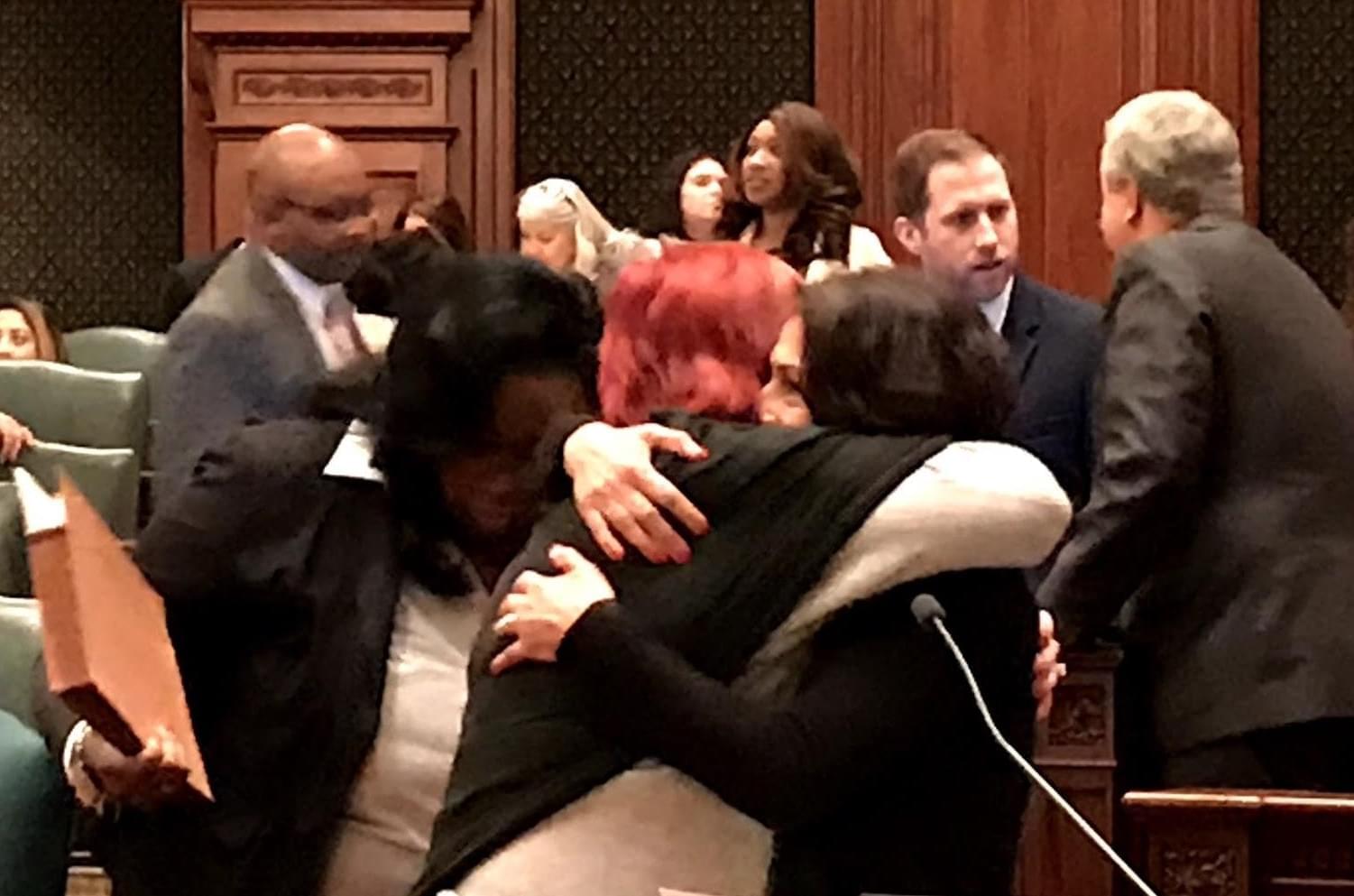 State Rep. Lisa Hernandez (D, left) receives a hug from Republican State Rep. Margo McDermed after the Illinois House votes to override Gov. Rauner's veto on the Voices Act on Nov. 28.