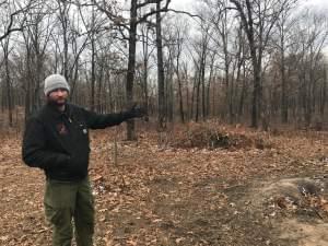 Mark Twain National Forest firefighter Mike Kelly points to a stand of trees in the process of being thinned out to help prevent wildfires.