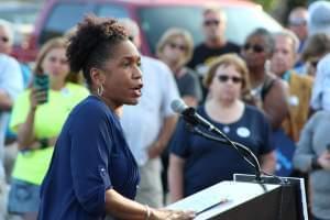 In this file photo from 2017, state Rep. Juliana Stratton stands at a campaign podium at a union rally in Springfield. 