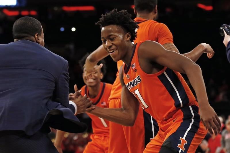 Illinois guard Ayo Dosunmu (11) celebrates with a coach after defeating No. 13 Maryland 78-67 in an NCAA college basketball game Saturday, Jan. 26, 2019, in New York. Illinois defeated Maryland 78-67.