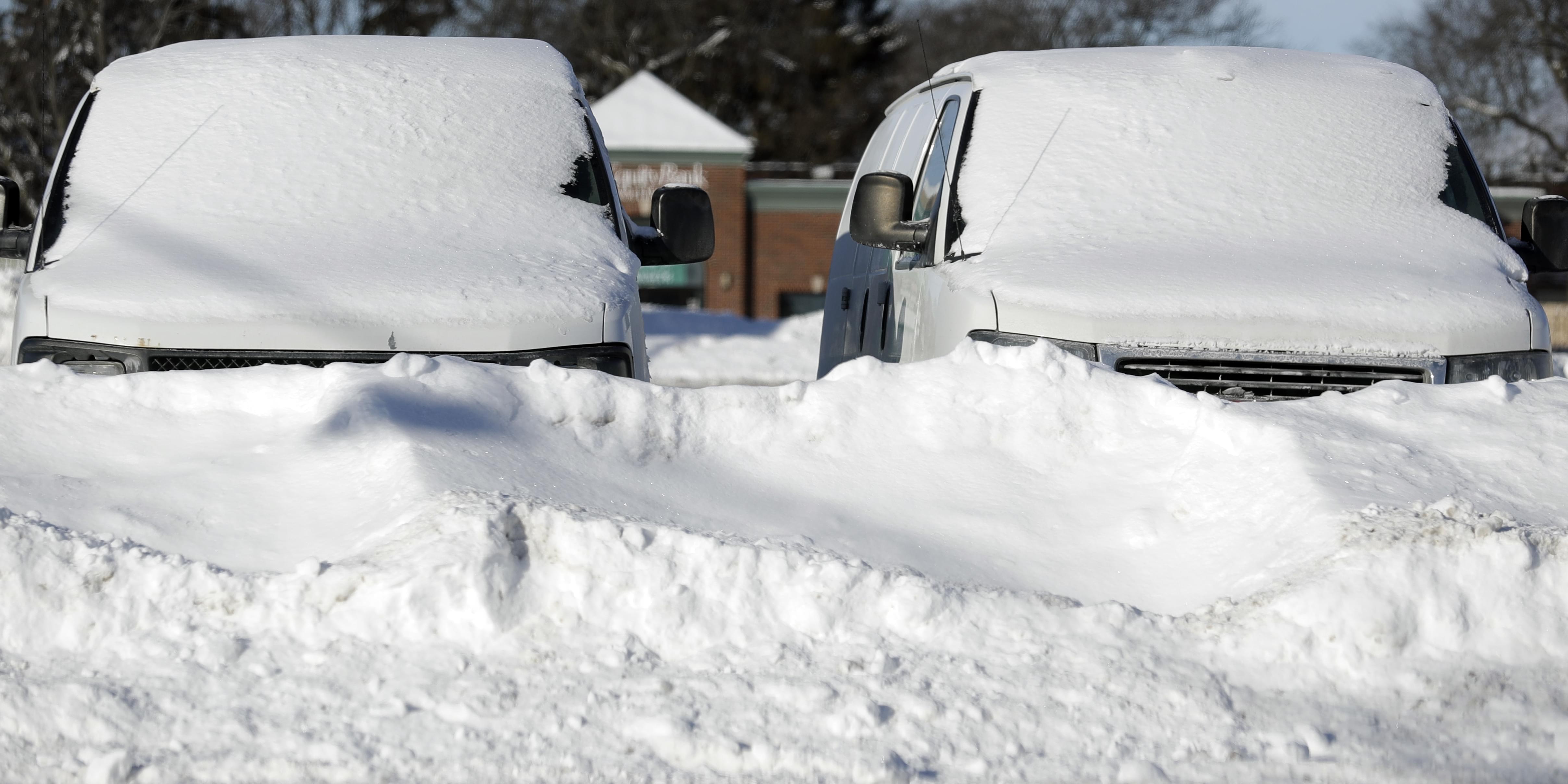 Cars are covered by snow in Buffalo Grove, Ill., Thursday, Jan. 31.