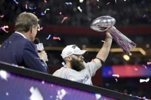 New England Patriots player Julian Edelman holds up the Lombardi trophy, after winning MVP in the Patriots' 13-3 Super Bowl win over the Los Angeles Rams.