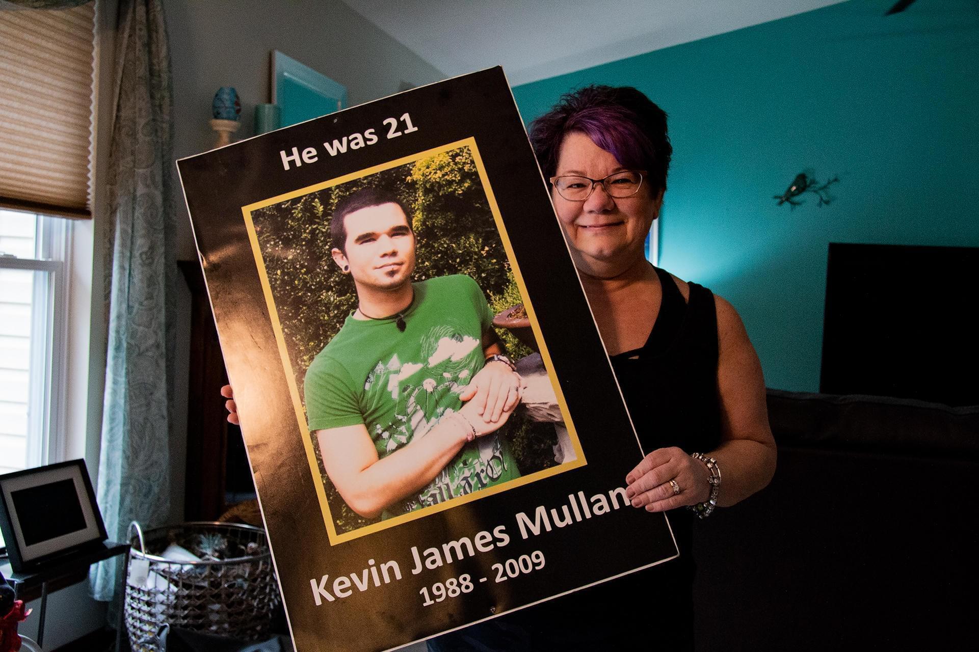 Kathi Arbini holds a photograph of her son, Kevin Mullane, who died of a heroin overdose at the age of 21.