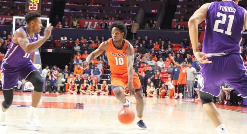 Illinois' Andres Feliz spies an opening between Northwestern defenders, Sunday in Champaign.