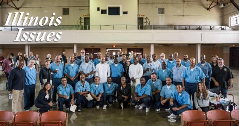 Students, teachers, staff and volunteers posed for a picture after a convocation ceremony for the fall semester of a masters degree program at Stateville Correctional Center.