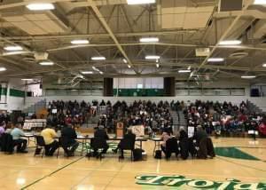 The Dwight Village Board, meeting at the Dwight Township High School gym, with hundreds attending.