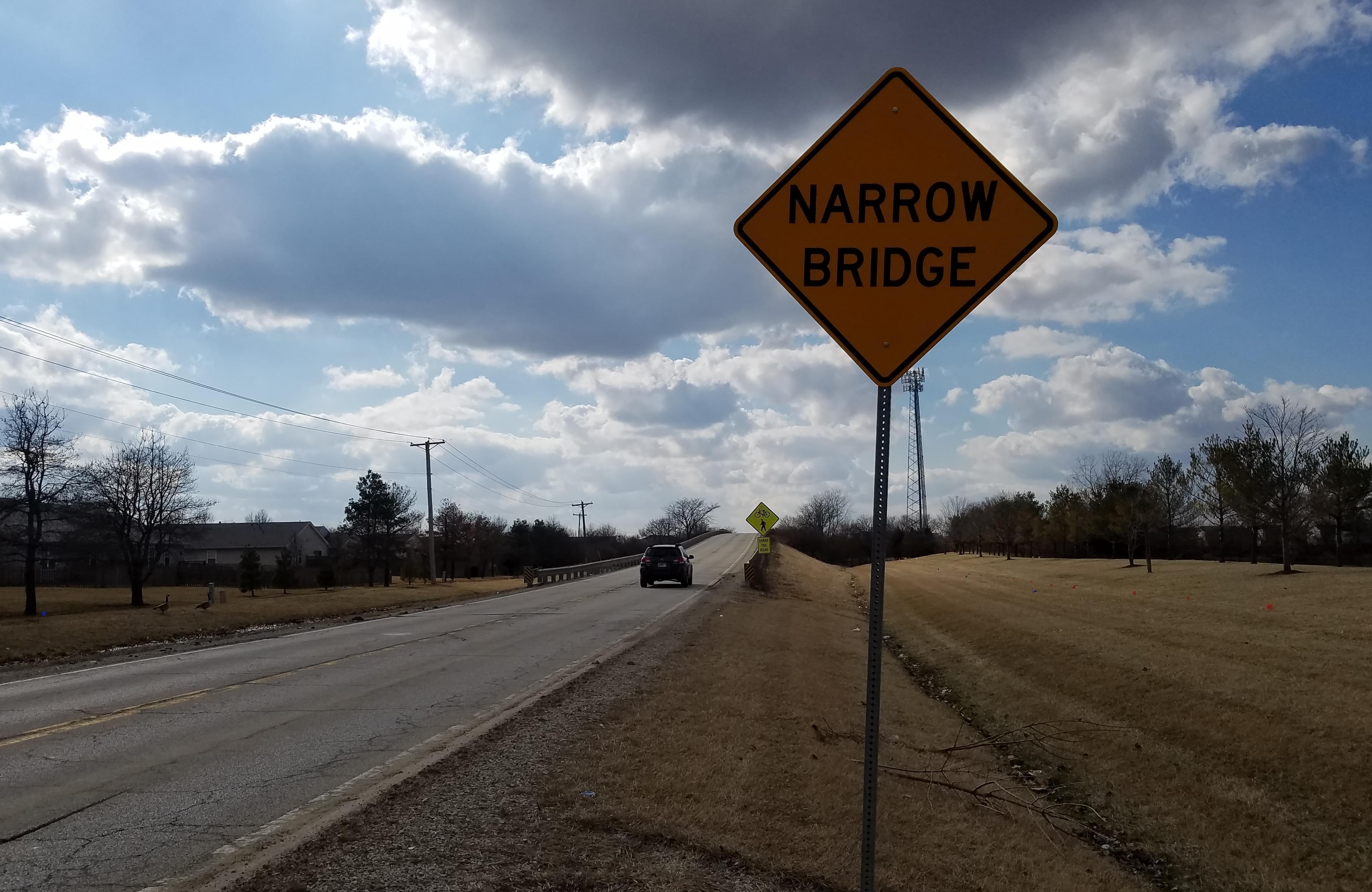 A "Narrow Bridge" sign is posted on the approach to the Bradley Avenue bridge over I-57 in Champaign. 