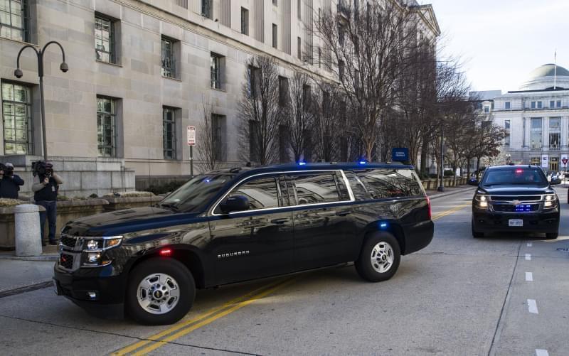 The motorcade for Attorney General William Barr arrives at the Department of Justice, Sunday in Washington.