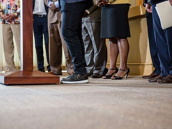 a photo of people's feet and legs in a courtroom