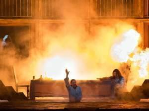 stage burns while two people perform