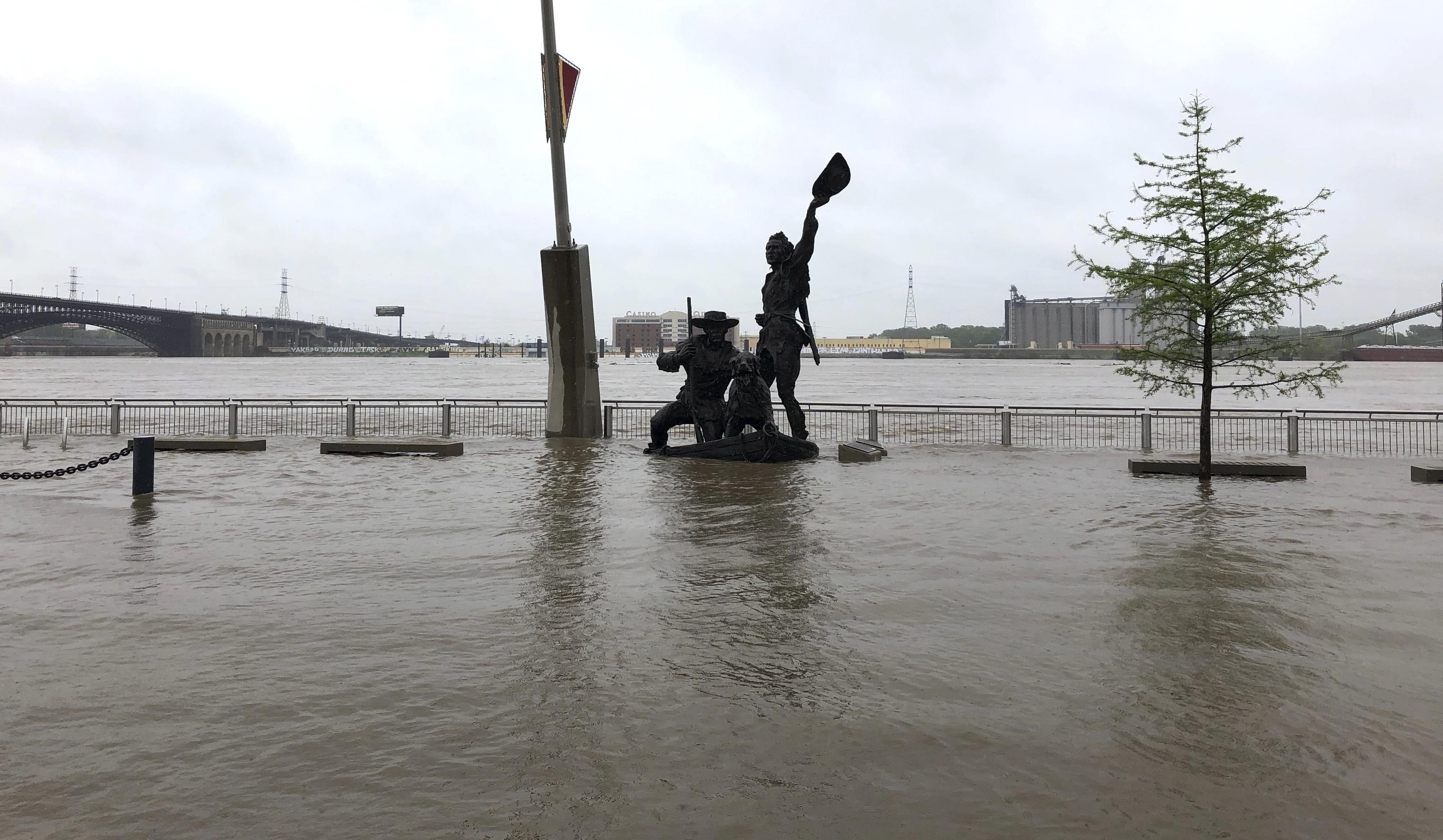 A statue of explorers Lewis and Clark is surrounded by floodwater along the St. Louis riverfront, Thursday, May 2, 3019. Several Mississippi River towns are seeing floods that are closing in on the historic levels reached in 1993.