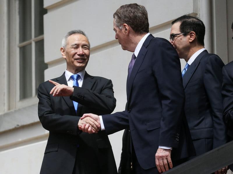 Chinese Vice Premier Liu He talks with U.S. Trade Representative Robert Lighthizer and Treasury Secretary Steven Mnuchin as they depart a round of trade talks in Washington on Friday.