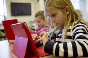 A second-grader works on an iPad. 