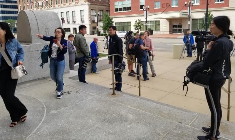 News media workers gathering outside the Federal Building & U.S. Courthouse in Peoria.