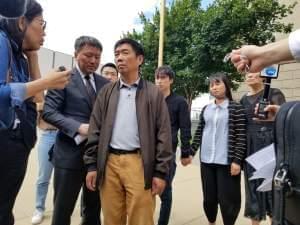 Yingying Zhang's family standing outside the federal courthouse in Peoria following the trial of Brendt Christensen. Media surrounds the family.