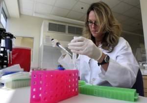 Heather Johnson performs DNA extraction at the Michigan State Police Forensic Laboratory in Delta Township, Mich.