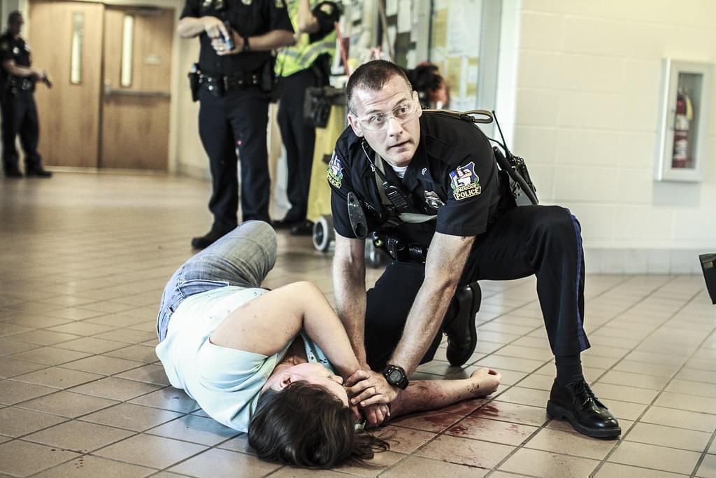 A Paducah Police officer aids a "victim" during an active-shooter mock exercise at West Kentucky Community and Technical College.