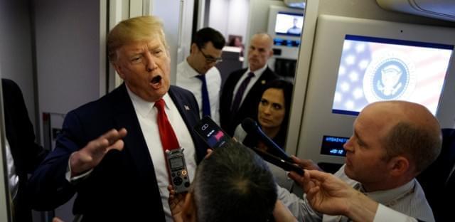 President Donald Trump talks to reporters aboard Air Force One after visiting Dayton, Ohio and El Paso, Texas, Wednesday, Aug. 7, 2019. 