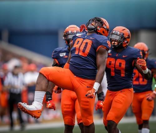 Illinois' Lere Oladipo celebrates after a sack with teammate Owen Carney during the Illini's 42-3 win over Akron.