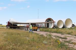 Rob Van Vleet secures a wind turbine blade onto an oversized truck at the Kimball Wind Farm in southwest Nebraska.