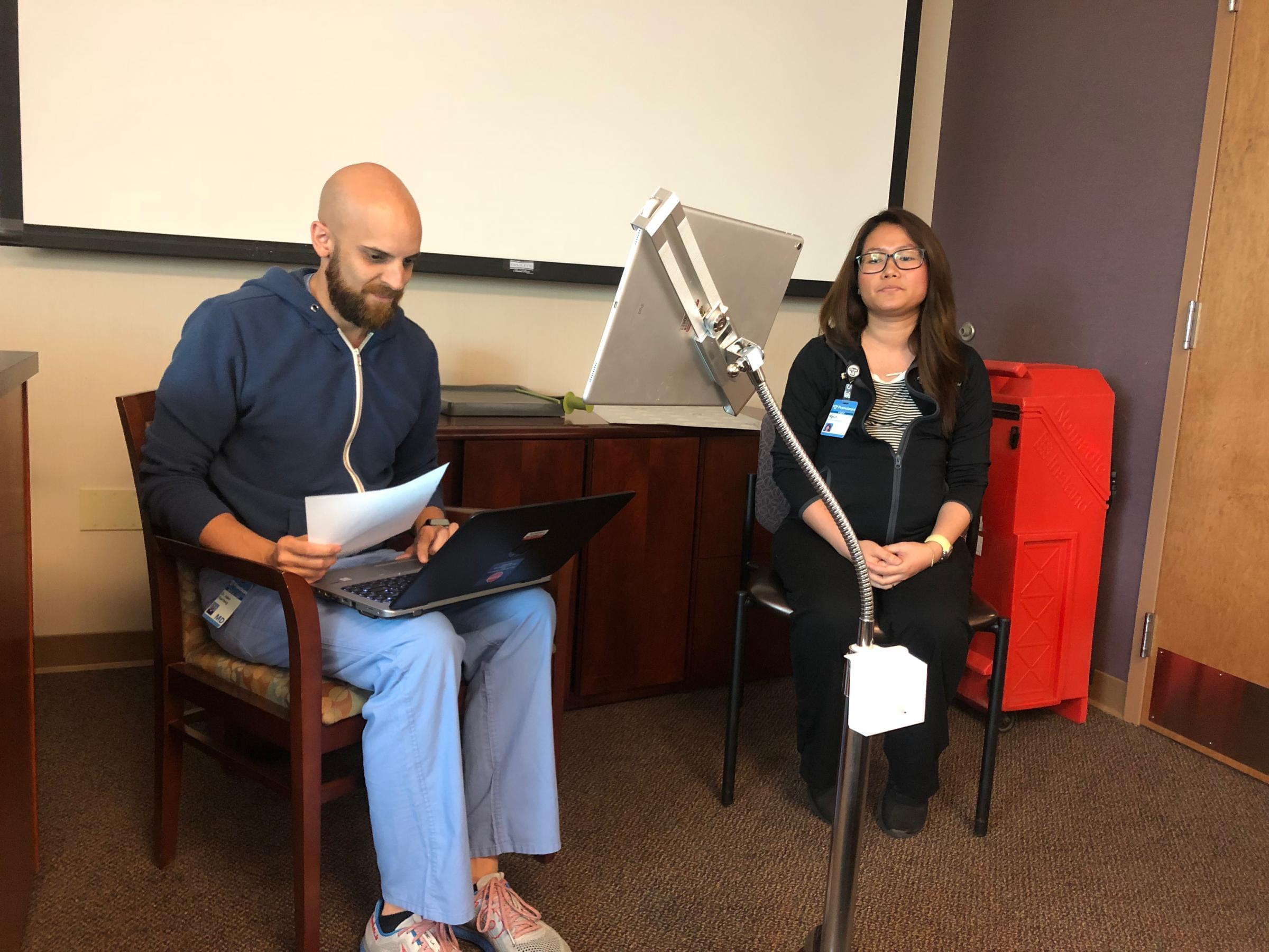 Adam Paarlberg and medical assistant Ngun Tial demonstrate how the live interpreter MARTI system works.