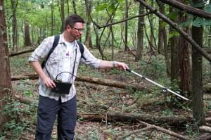 Ben Jellen, an associate professor of biology at St. Louis College of Pharmacy, uses a radio receiver to track a copperhead snake at Powder Valley Nature Center. Jellen is leading the study, which aims to better understand copperhead biology.